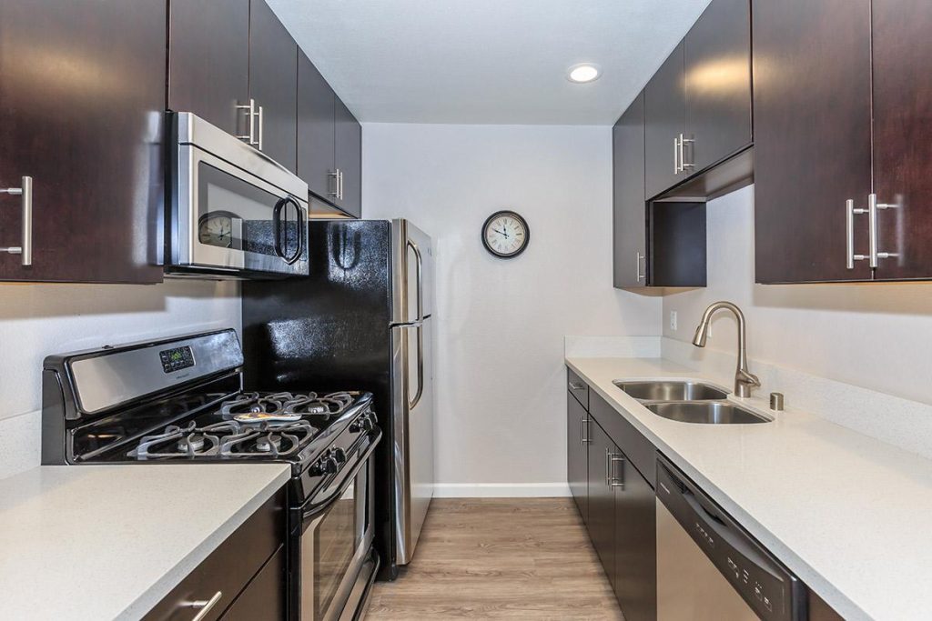 Discover modern apartments in Hollywood, CA featuring stylish stainless steel appliances and chic wood cabinets.