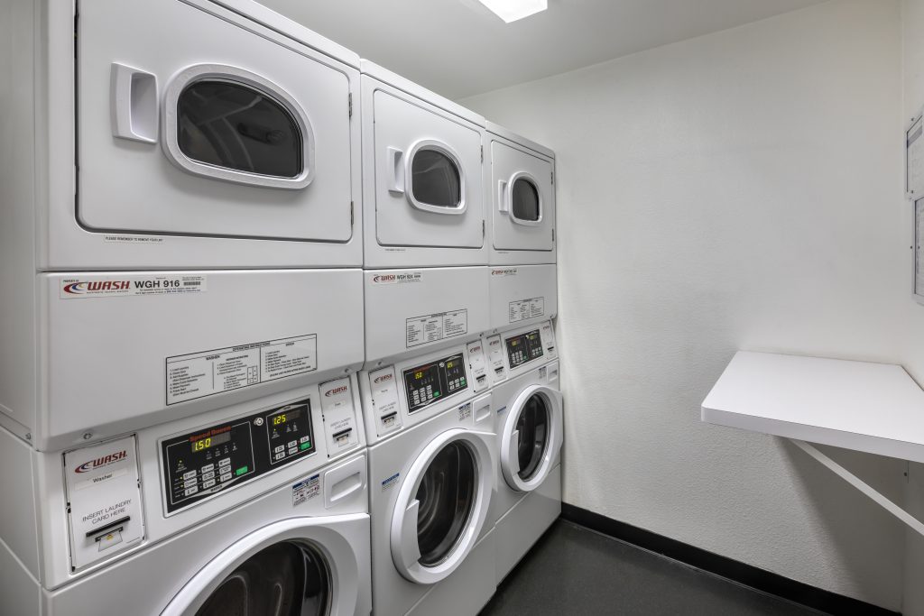 A laundry room equipped with multiple washers and dryers, conveniently available for tenants of apartments in Hollywood CA.