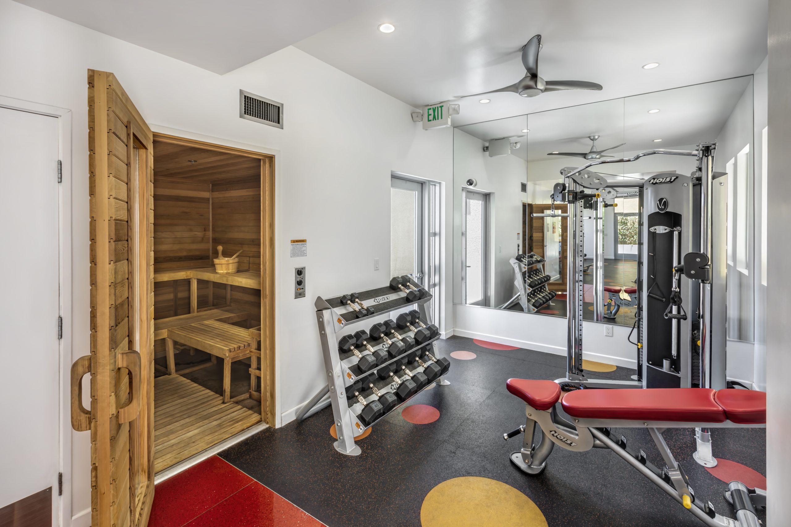An apartment in Hollywood, CA featuring a gym room with weights and a mirror.