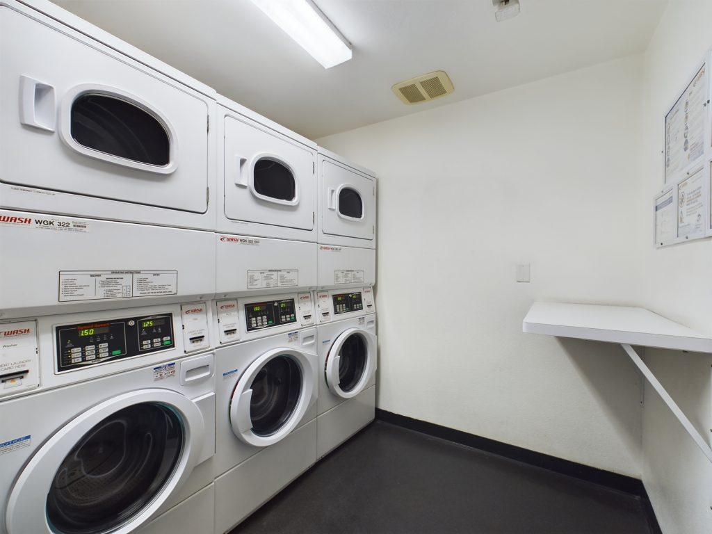 A laundry room with washers and dryers available for residents of apartments in Hollywood CA.