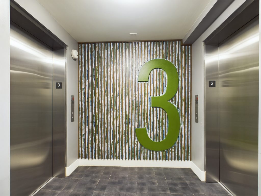 An elevator with the number 3 on it in apartments for rent Hollywood CA.